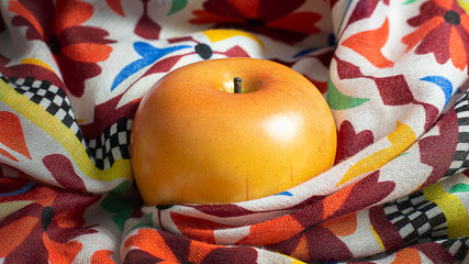 Apple on scarf low light for food content.