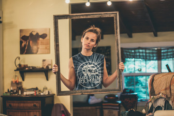 A woman standing in the middle of a house within a floating picture frame