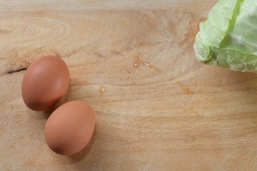 fresh cabbage organic vegetable and egg put on wood cutting board in kitchen prepare cooking food