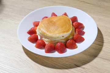 pancake and strawberry fruit sweet dessert food put on breakfast table