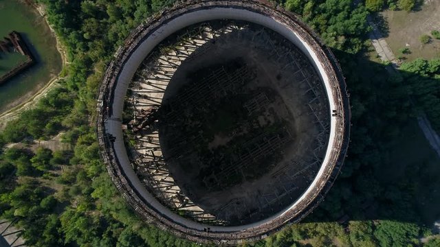 Aerial top view of unfinished cooling towers for fifth and sixth nuclear reactors of third stage of Chernobyl nuclear power plant. Exclusion Zone. Vertical tracking shot. 4K drone footage