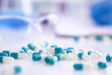 Tablets scattered on the table of the pharmaceutical laboratory pill for the prescription and...