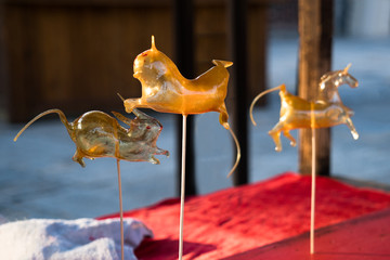 Chinese traditional snack sugar blowing man.Chinese traditional temple fair delicacies old Beijing...