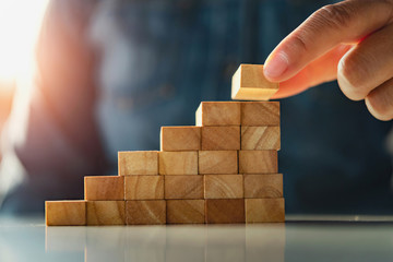 close up of hand businessman playing block wood