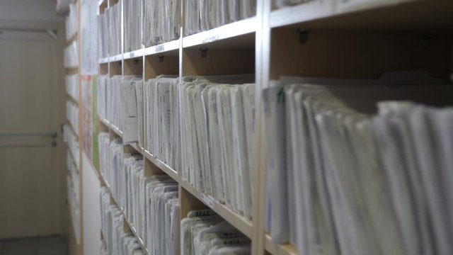 Patient Card Register in dentist office. Health insurance folder in archive files, Medical records. catalog in clinic. Healthcare clinic. Old-fashioned medical cards on shelves in hospital. 4k footage