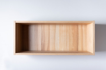 Blank wooden wall shelf with lighting on a white.