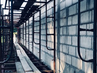 Cement brick wall and scaffolding structure at construction site
