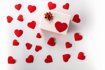Box.  Holiday box with a red heart pattern and lots of red cardboard hearts on a white background. View from the top. Valentine's day and Birthday