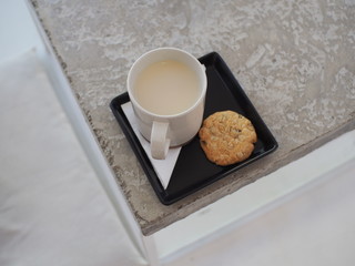 A mug of soy milk with healthy grain cookie.