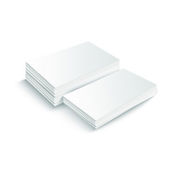 Two stacks of blank business cards of different heights on white background with soft shadows. 