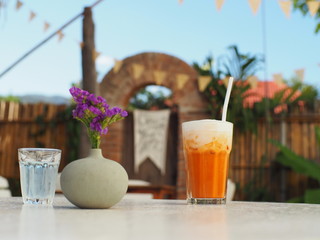 Coffee and Thai milk tea in backyard garden on sunny day