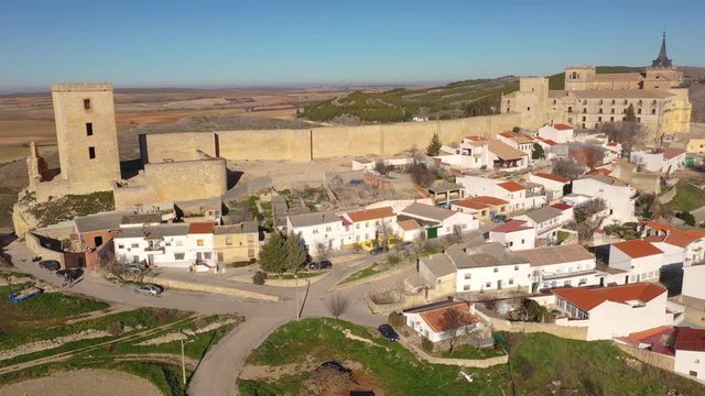 Aerial view of Ucles castle and monastery with two keeps gates and towers encircling a bailey in Cuenca Spain