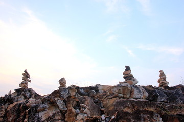 Stone sort at the sea or beach on the sunset, zen stone.Stones pyramid on rock Ocean in the...