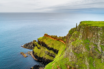 Northern Ireland, UK. Cliffs at Atlantic coast in County Antrim with visible geological strata, and...