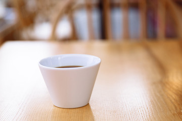 Cup of coffee on a wooden table.