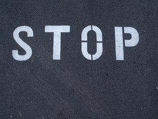 Stop sign painted on the asphalt