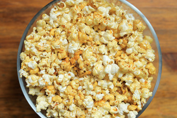 Panorama of glass bowl with popcorn, top view