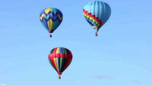 Colorful hot air balloons in clear blue sky, 4k