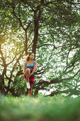 Sporty young black woman doing stretching at park in the morning,Fit girl warming up at outdoor,Happy and smiling