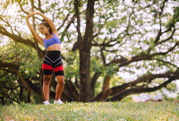 Blured sporty black woman doing stretching at park in the morning,Fit girl warming up at outdoor