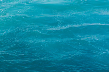 Blue sea surface with waves abstract background pattern