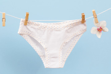 Beautiful women's cotton panties on blue background.