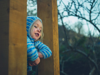 Preschooler climbing bars of calisthenics gym