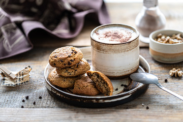 Homemade cookies with nuts and coffee in a ceramic cup