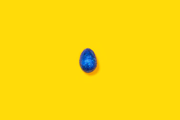 Blue easter egg on a yellow background.