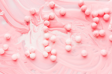 Drops, splashes and stain liquid pink paint with round balls, painted abstract background, texture.