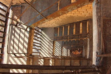 Old spiral fire escape in a residential building, top-down view in perspective