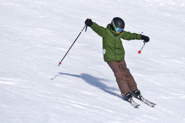 Fototapeta na wymiar Young Skier Skiing Down a Slope
