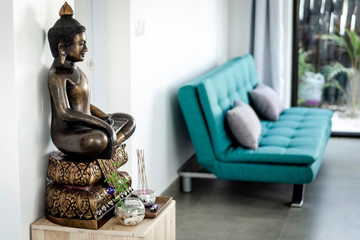 bronze buddha statue interior design detail in modern asian home