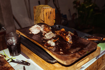 Traditional suckling pig cooked on the charcoal grill. The little pig is roasted whole on an open fire. Organic pig on the spit.