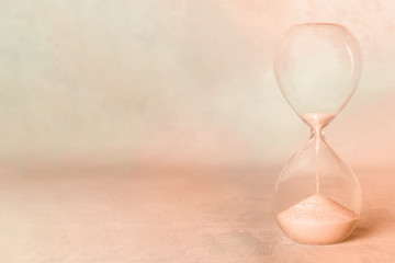 A vintage hourglass with copyspace. Old age, nostalgia concept, sepia-toned image
