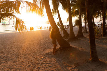 Beautiful girl at sunset on the beach having fun and enjoying life. Boracay Island in the...