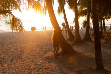 Beautiful girl at sunset on the beach having fun and enjoying life. Boracay Island in the...