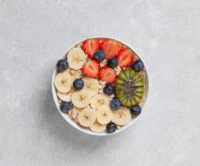 Delicious healthy Breakfast. Smoothie bowl with granola, yogurt, fruit and berries. Top view