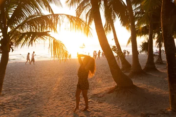 Keuken foto achterwand Boracay Wit Strand Beautiful girl at sunset on the beach having fun and enjoying life. Boracay Island in the Philippines. Against the background of cliffs, beach and sea. White beach