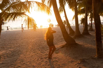 Photo sur Plexiglas Plage blanche de Boracay Beautiful girl at sunset on the beach having fun and enjoying life. Boracay Island in the Philippines. Against the background of cliffs, beach and sea. White beach