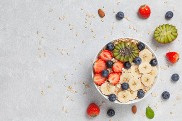 Delicious healthy Breakfast. Smoothie bowl with granola, yogurt, fruit and berries.