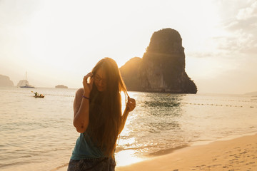 Beautiful girl at sunset on the beach having fun and enjoying life. In Krabi province in Thailand....