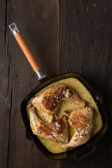 Fried chicken legs in a pan, rustic style, top view