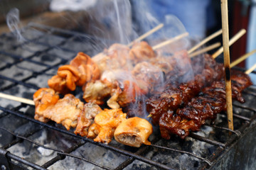 Grilled pork intestine in barbecue sticks sold at a street food stall