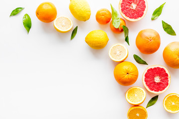 Fresh citrus frame. Oranges, tangerines, grapefruits, leaves on white background top-down copy space