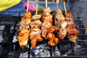 Grilled pork intestine in barbecue sticks sold at a street food stall