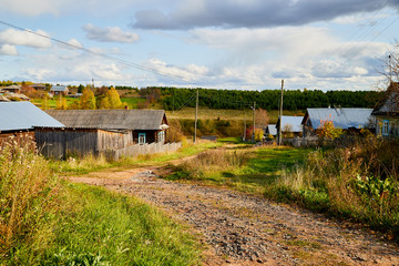 Village street with wooden house in summer day. Traditional old house in Russia