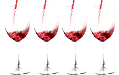 Red wine poured into crystal glasses. Isolated on white background. Four glasses of wine. Copy space.