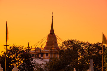 Fototapeta na wymiar Wat Phu Khao Thong at Thailand on the morning sunset