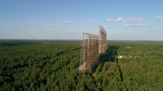 Aerial view of the DUGA radar station near the city of Chernobyl-2 among the forest. Exclusion Zone. 4K drone footage.